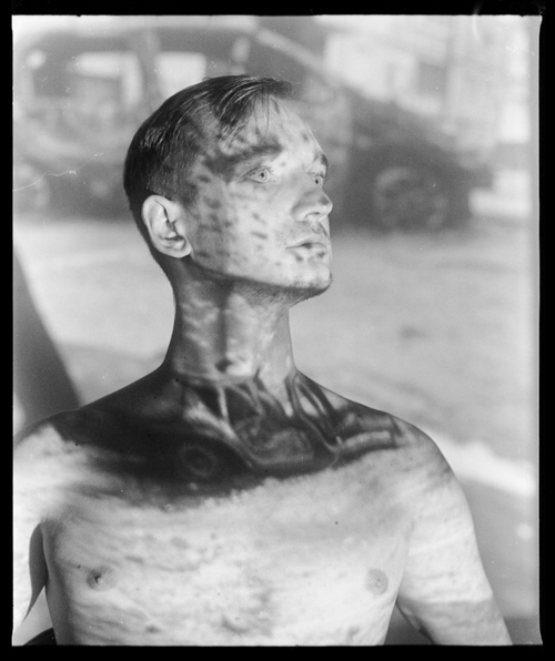 ANTON WITH A PROJECTION OF HIS SHOT HOUSE IN MYKOLAIV (IVANO-FRANKIVSK, 2023) by Sergey Melnitchenko