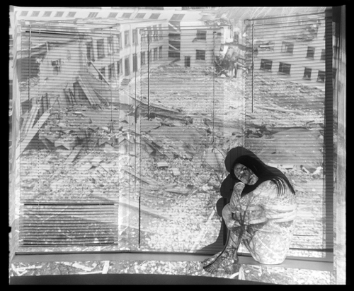 MARIA WITH A PROJECTION OF HER BOMBED SCHOOL IN SUMY (IVANO-FRANKIVSK, 2023) by Sergey Melnitchenko