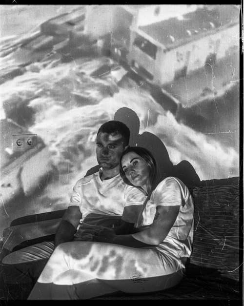 PASHA AND MASHA WITH A PROJECTION OF THE BLOWN UP KAKHOVKA DAM. AT THE TIME OF THE EXPLOSION, THEIR PARENTS WERE IN THE OCCUPIED TERRITORY (ODESA, 2023) by Sergey Melnitchenko